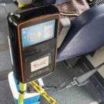 Tourist tapping a T-money transit card at a bus